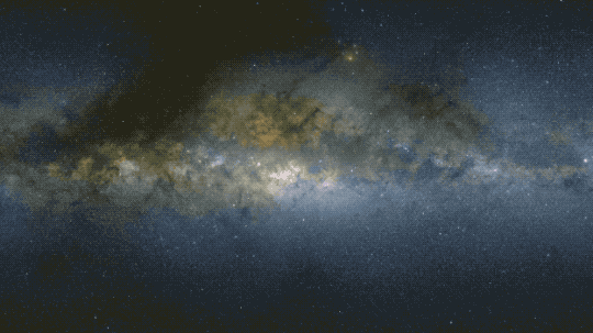 This animation zooms into an image of the Milky Way, starting with visible light, which looks like puffy clouds of material in shades of light yellow with dark lanes between and stars, as tiny dots, densely packed throughout. At the center is overlaid a gamma-ray map as a purple circle with a bullseye with red at the very center surrounded by yellow, green and blue, representing the strength of the gamma-ray detections, with red being the greatest number of photons detected. When all the known sources are removed, a gamma-ray excess hints at the presence of dark matter.